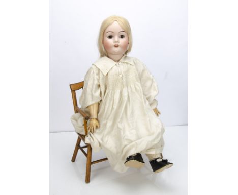 A large Max Handwerck 283 child doll,  with brown lashed sleeping eyes, replaced blonde wig, jointed composition body, silk c