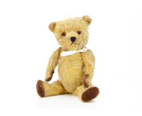 An early post-war Chiltern Hugmee teddy bear,  with golden mohair, orange and black glass eyes, black stitched nose and mouth