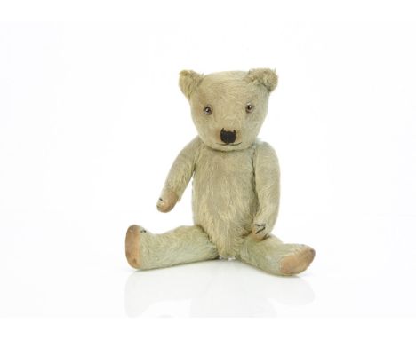 A Chiltern-type blue mohair teddy bear 1930s,  with clear and black glass eyes with brown painted back, slight pronounced muz