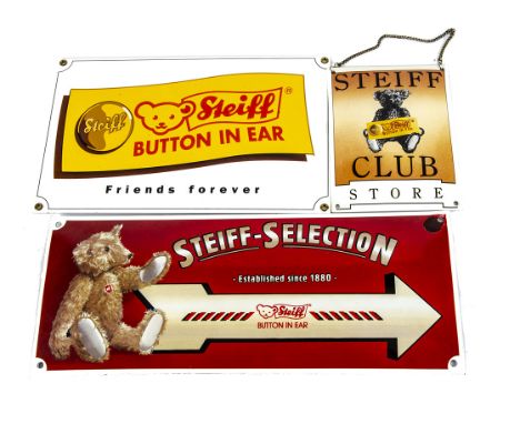 Three Steiff enamel advertising signs,  a 'Steiff Selection' arrow sign --15¾in. (40cm.) wide; a 'Friends Forever' with butto