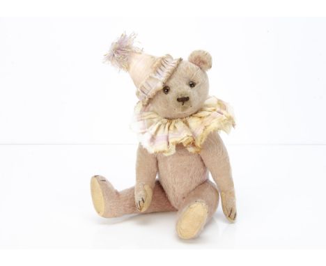 A German pink mohair teddy bear 1920-30s,  with clear and black glass eyes with brown backs, brown stitched nose and claws, s