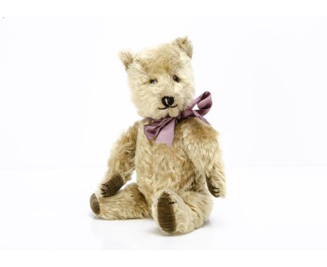 A post-war Chiltern Hugmee teddy bear,  with light golden mohair, orange and black glass eyes, pronounced muzzle, black stitc