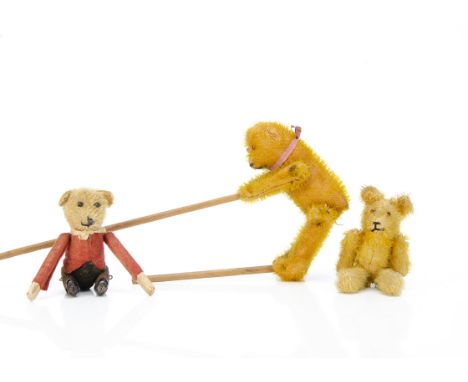 Two acrobatic teddy bears, a short-golden mohair bear with orange and black glass eyes, black stitched nose and mouth, pin-jo