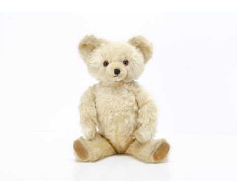 A Knickerbocker white mohair musical teddy bear 1950s,  with orange and black glass eyes, inset short mohair muzzle, black st