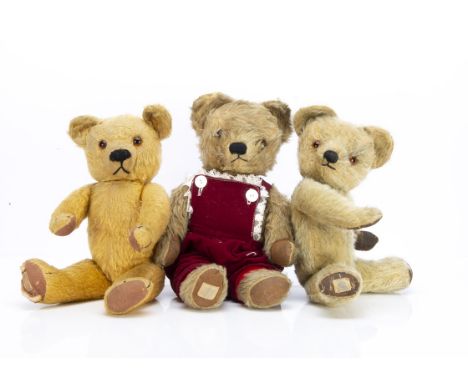 Three Chad Valley teddy bears, a 1930s bear with golden mohair, orange and black glass eyes, black stitched nose, mouth and c