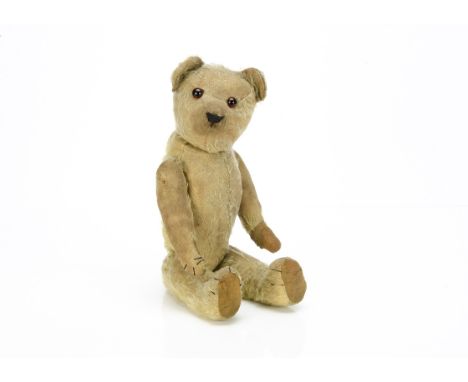 A 1920s pin-jointed Chad Valley teddy bear,  with golden mohair, replaced orange and black glass eyes, pronounced muzzle, bla