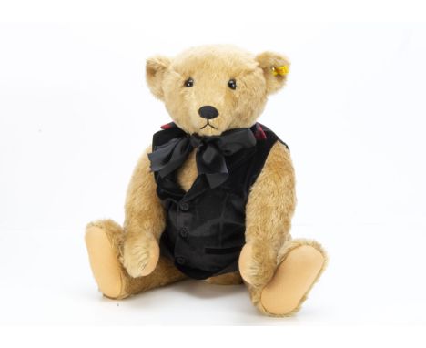 A Steiff yellow tagged Margaret Strong teddy bear,  tag number 0155/60 in recent black waistcoat and ribbon --24in. (61cm.) h