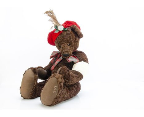 A  large Kyle brown sheepskin Scottish teddy  bear,  fully jointed with Tam O'Shanter and tartan ribbon --30½in. (77.5cm.) hi