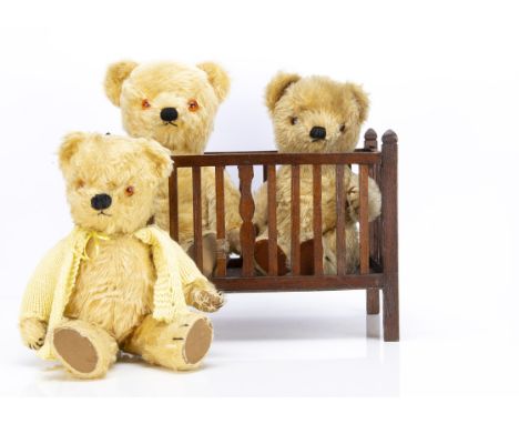 Three post-war Chad Valley teddy bears,  all with golden/mixed mohair, orange and black plastic eyes, black stitched nose and