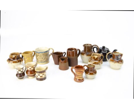 Small stoneware vessels, a head jug --2in. (5cm.) high, a mug with textured finish; a jug embossed with grapevines; three inc