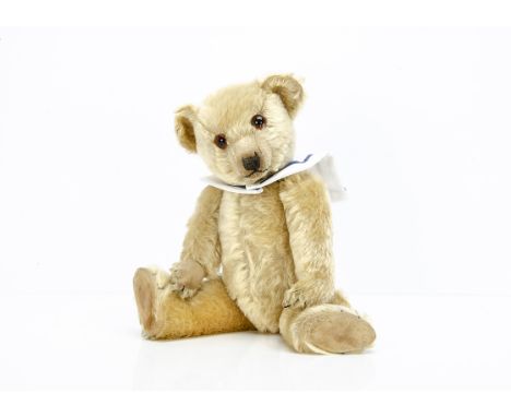 A 1930s Chiltern Hugmee teddy bear,  with blonde mohair, orange and black glass eyes, pronounced clipped muzzle, black stitch