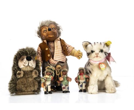 A Steiff seated Susi tabby cat, with swivel head, script button with yellow cloth tag and card chest tag --7½in. (19cm.) high