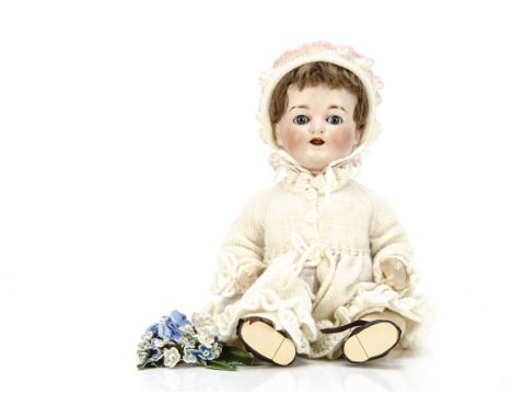 A German K &amp; Co 435 character baby,  with blue sleeping eyes, brown mohair wig, bent-limbed composition body, cream knitt