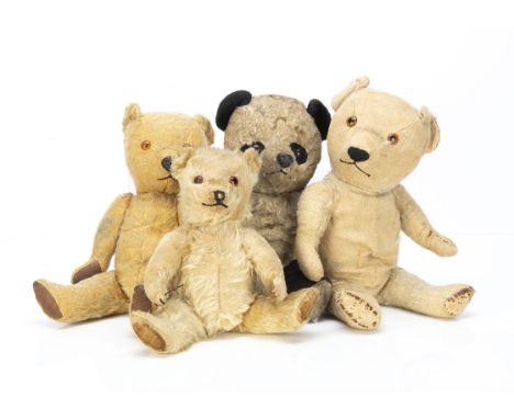 Four post-war Chiltern teddy bears,  a small Hugmee with glass eyes and velvet pads --11½in. (29cm.) high (a little balding a