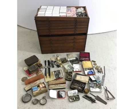 Eleven drawer wooden watchmakers chest, one drawer containing a quantity of watch mainsprings; together with a quantity of wa