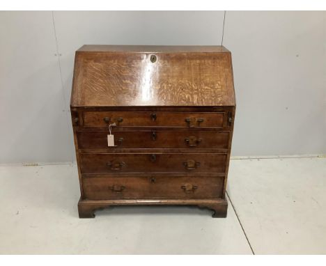 A George III oak bureau, with four long graduated drawers, on bracket feet, width 92cm, depth 50cm, height 100cm. Condition -