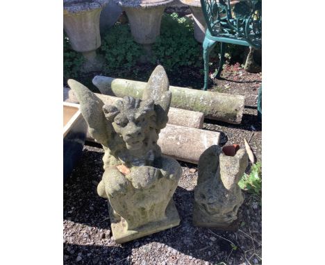 Two reconstituted stone winged lion and gargoyle garden ornaments, larger height 56cm. Condition - fair