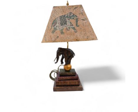 A Thomas Blakemore style ‘elephant’ and faux book table lamp with shade, 64cm. Condition - good, not tested as working