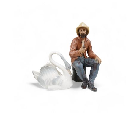 A large Nao seated figure of a fisherman and a similar swan, largest 41cm high. Condition - good