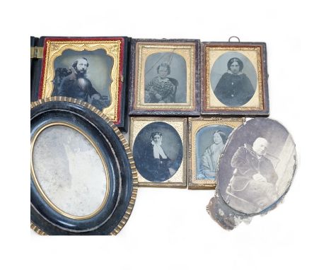 A collection of Victorian ambrotype and black and white photographs including two with original cases, largest 14cm high over