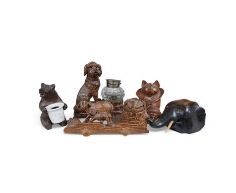 A collection of five carved wooden novelty animal inkwells, four black forest, tallest dog inkwell 15cm high. Condition - som