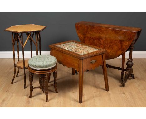 A group of occasional furniture comprising an oak framed occasional table with glass top over floral tapestry panel, lifting 