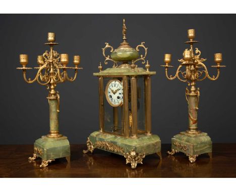 A late 19th / early 20th century French gilt metal and onyx garniture du cheminee clock, the enamelled dial with arabic and r