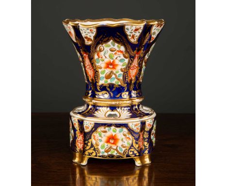 An early 19th Century Spode flower vase and stand, the blue and gilt background with floral panels, iron red painted factory 