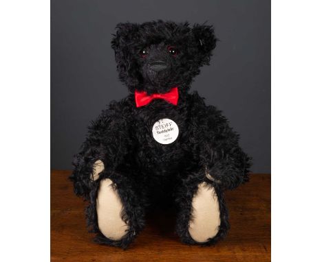 A large Steiff replica 1912 teddy bear with black mohair and numbered 557/1912, approximately 70cm high with original boxCond