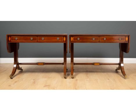 A pair of reproduction mahogany and stainwood crossbanded sofa tables each 94cm wide (flaps down) x 62cm deep x 70cm highCond