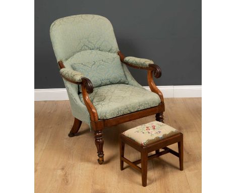 An oak framed armchair with scrolled arms on baluster turned supports and casters, and blue upholstery, 56cm wide x 60cm deep