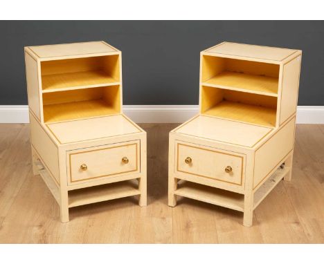 A pair of cream painted bedside cabinets of stepped form with fixed shelf and a single drawer with brass knob handles, each 4