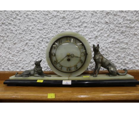 Early 20th century marble mantle clock decorated with two metal dog ornaments, 57 cm long, 23 cm high  