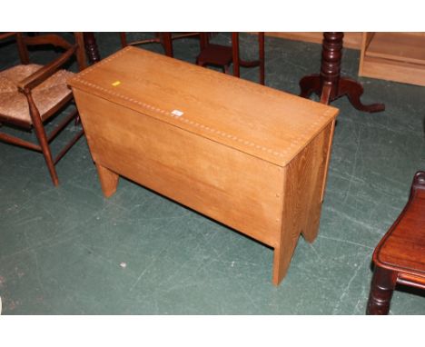 A light oak bedding chest with patterned border 