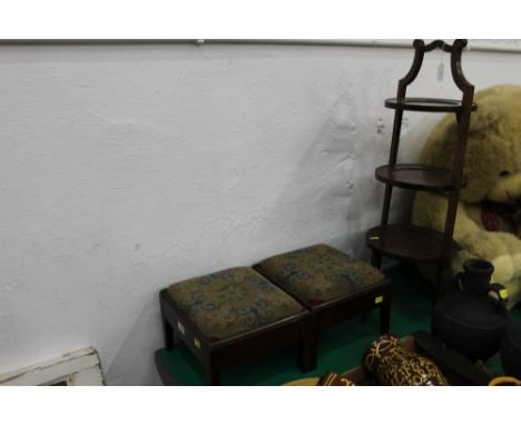 Two early 20th century footstools with tapestry seats and a folding cake stand