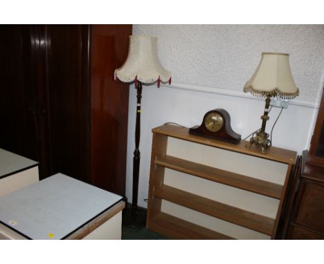 A mahogany lamp standard with cream tasselled shade 