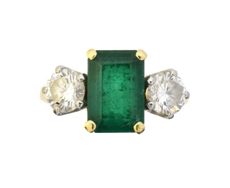 An 18ct gold emerald and diamond ring by Garrard, An 18ct gold emerald and diamond ring by Garrard, the emerald weighing appr