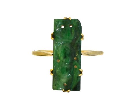 A jade dress ring, A jade dress ring, the rectangular carved jade panel within a six claw setting, stamped 18ct, ring size Q,