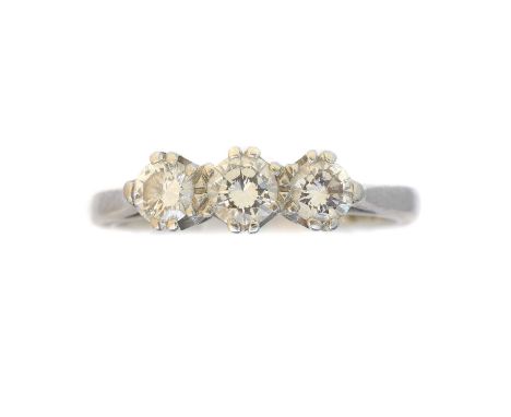 A platinum diamond three stone ring,  A platinum diamond three stone ring, the brilliant cut diamond line with shared claw se