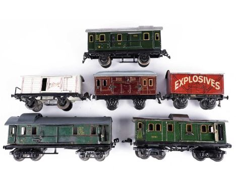 Three Marklin 0-gauge passenger carriages; a Bing 0-gauge explosives van; a Bing 0-gauge coach; and another. (6)
