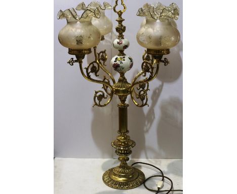 Large brass five branch table lamp with glass shades, one shade with hole, H: 84 cm. All electrical items in this lot have be