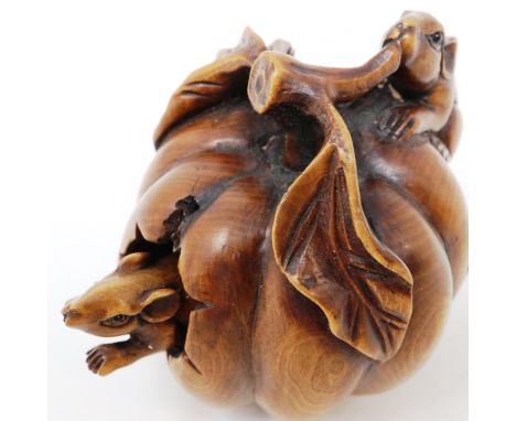 Japanese carved wood netsuke, in the form of a pumpkin with two mice, one reticulated mouse emerging from the pumpkin, bearin