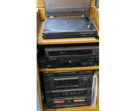 Aiwa stacking stereo system in an oak cabinet, 48 x 45 x 89 cm. All electrical items in this lot have been PAT tested for saf