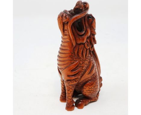 Japanese carved wood netsuke, in the form of a howling shishi, bearing signature, H: 65 mm. UK P&amp;P Group 1 (£16+VAT for t