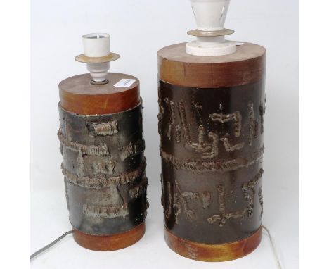 Two mid century wooden lamps with bound metal decoration, largest H: 30 cm. All electrical items in this lot have been PAT te