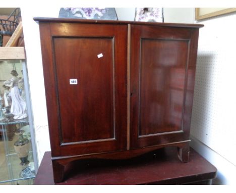 Edwardian hall cabinet with panelled front on bracket feet