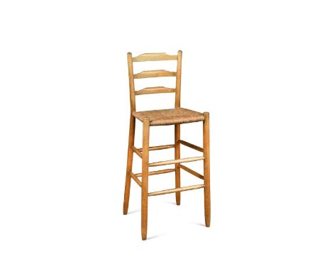 J. Starling, a Cotswold School ash high chair,  the ladder back above rush seat and turned supports united by a pair of stret