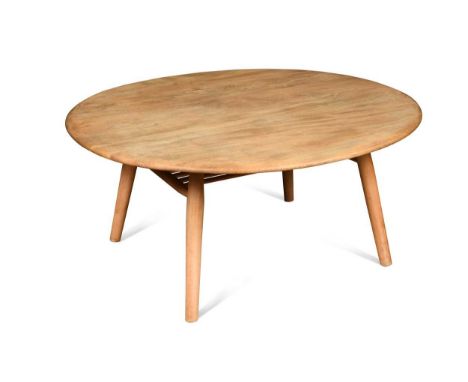 An Ercol elm coffee table,  the oval top on turned supports with undertier below, original paper label46 x 99 x 89cm