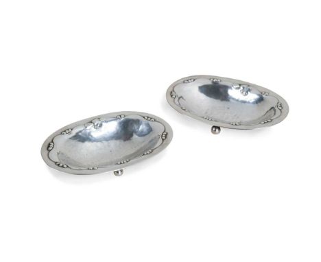 Georg Jensen (1866-1935), a pair of silver open salts, pattern no. 243B, in the 'Magnolia' pattern, each of shallow oval form