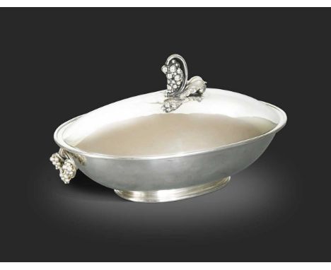 Georg Jensen (1866-1935), a Danish silver tureen and cover, pattern no. 408B, of oval form on a small stepped base, with frui